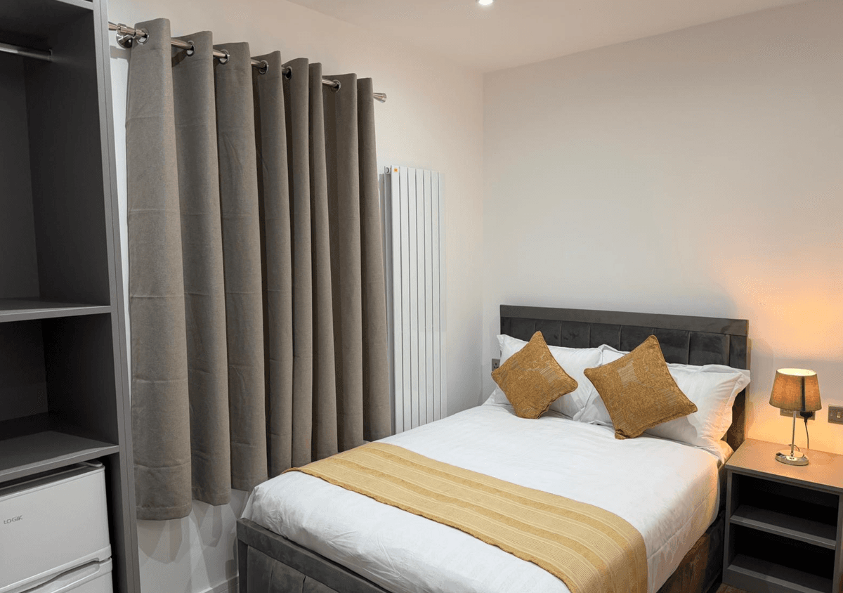 Bedroom with wardrobe & curtains
