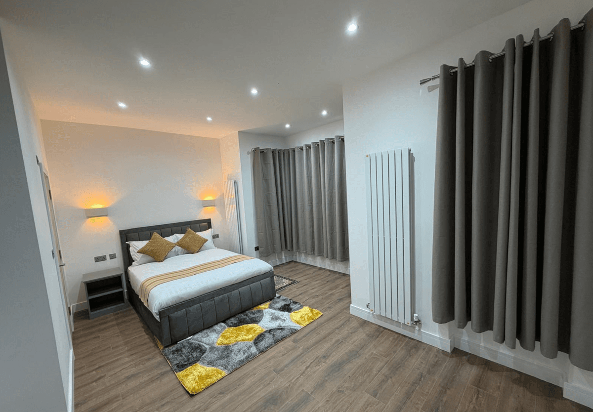 Spacious bedroom — yellow rug